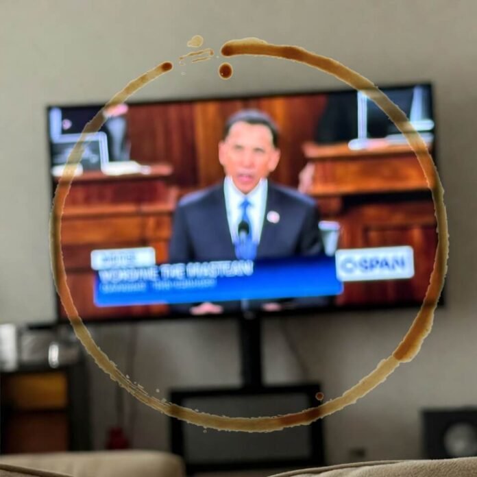 Tilted phone photo of C-SPAN on TV with coffee ring stain Tilted phone photo of C-SPAN on TV with coffee ring stain